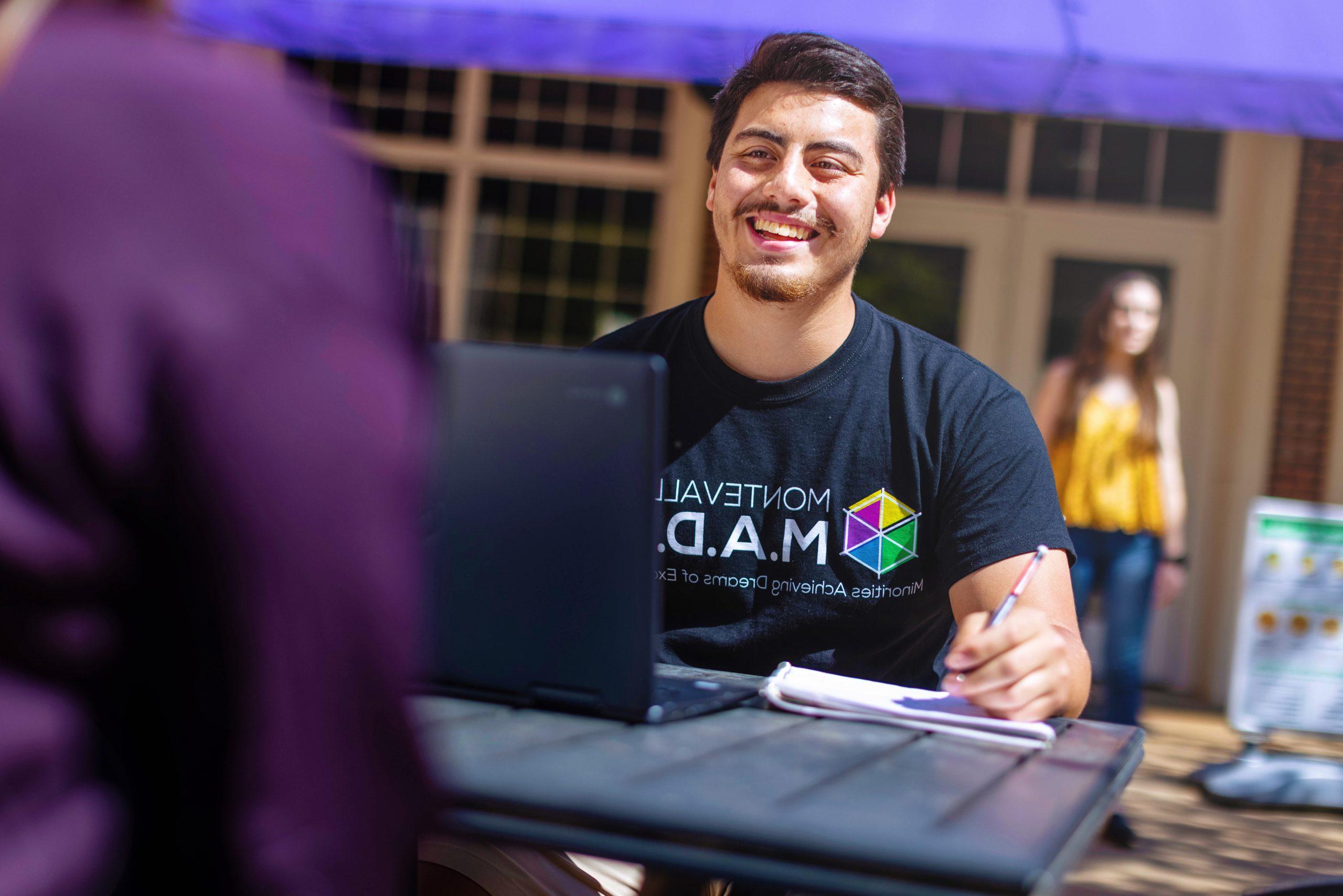 A 澳门在线赌城娱乐 student smiles during a conversation with a friend during a conversation on the Farmer Hall patio.